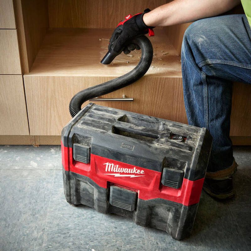 Action shot of the MILWAUKEE® M18 Wet/Dry Vacuum in use, showcasing its high-powered 18V motor and HEPA filtration, effectively clearing debris on a jobsite with onboard accessory storage for added convenience. Action shot of the MILWAUKEE® M18 Wet/Dry Vacuum in use, showcasing its high-powered 18V motor and HEPA filtration, effectively clearing debris on a jobsite with onboard accessory storage for added convenience.